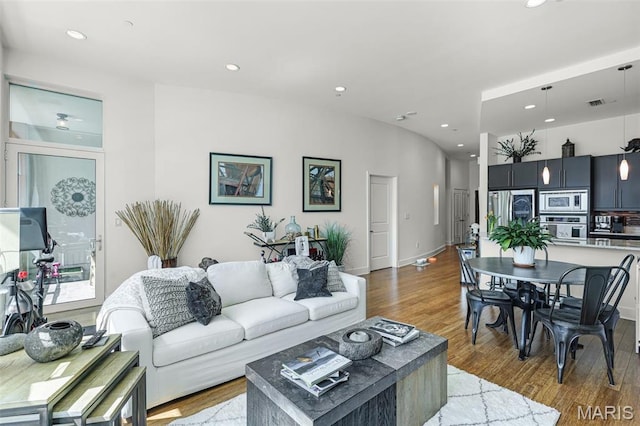 8025 Maryland Ave Unit 2H, Saint Louis, MO 63105 - living room featuring wood finished floors, recessed lighting, and baseboards