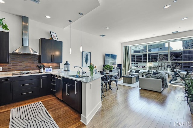 8025 Maryland Ave Unit 2H, Saint Louis, MO 63105 - kitchen with wall chimney exhaust hood, a sink, a peninsula, stainless steel appliances, and backsplash