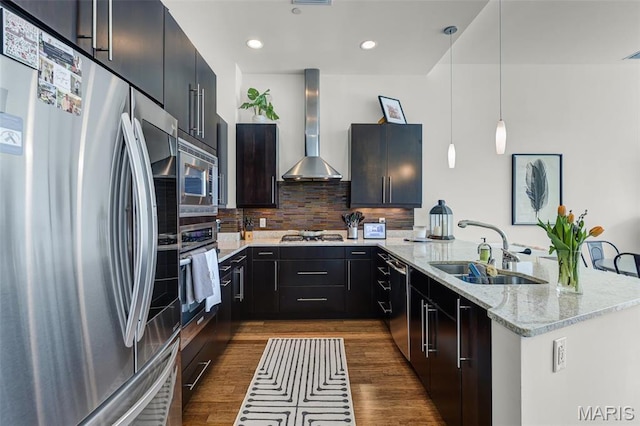 8025 Maryland Ave Unit 2H, Saint Louis, MO 63105 - kitchen with stainless steel appliances, a sink, wall chimney range hood, a peninsula, and dark wood finished floors