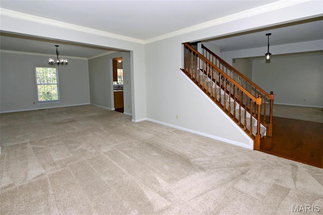 unfurnished living room with a chandelier, carpet flooring, ornamental molding, and baseboards