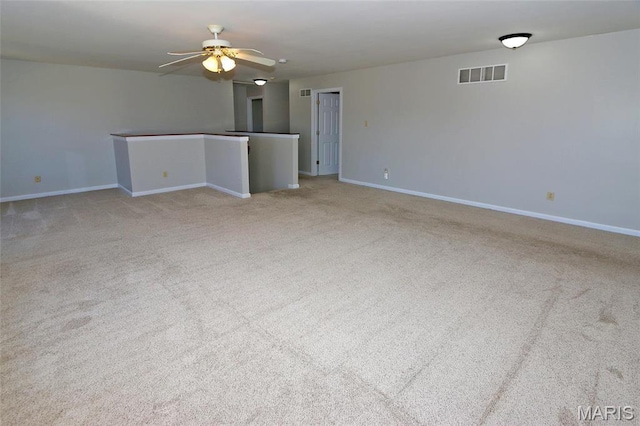 empty room featuring baseboards, carpet flooring, and a ceiling fan
