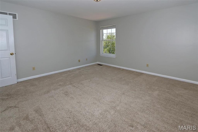 carpeted empty room with baseboards
