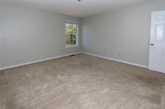 unfurnished room with carpet floors and baseboards