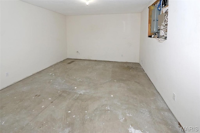 spare room featuring concrete floors and electric panel
