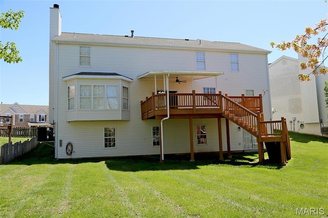 back of house with a deck, a ceiling fan, a chimney, and stairs