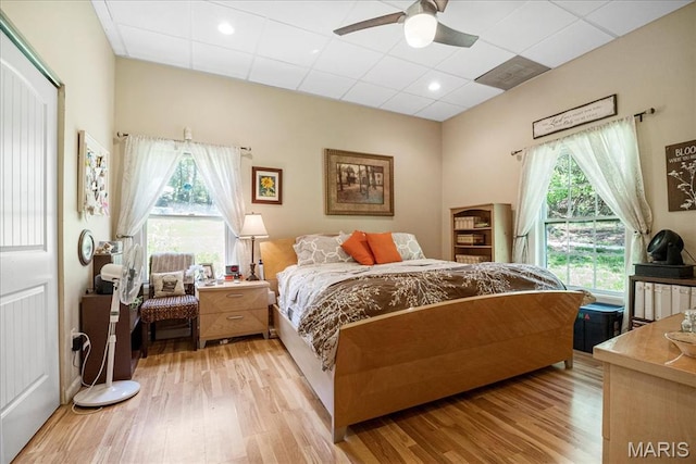 1909 Shepard Rd, Wildwood, MO 63038 - bedroom featuring light wood-type flooring, multiple windows, a paneled ceiling, and a ceiling fan