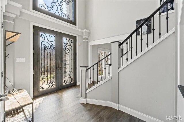 1909 Shepard Rd, Wildwood, MO 63038 - foyer entrance featuring french doors, a towering ceiling, baseboards, stairs, and dark wood-style floors