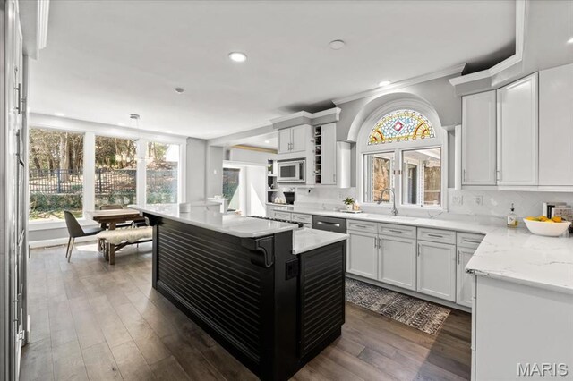 1909 Shepard Rd, Wildwood, MO 63038 - kitchen with a sink, appliances with stainless steel finishes, dark wood finished floors, ornamental molding, and pendant lighting