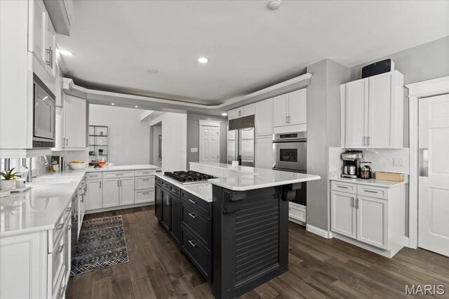 1909 Shepard Rd, Wildwood, MO 63038 - kitchen with dark cabinetry, white cabinets, built in appliances, light countertops, and recessed lighting