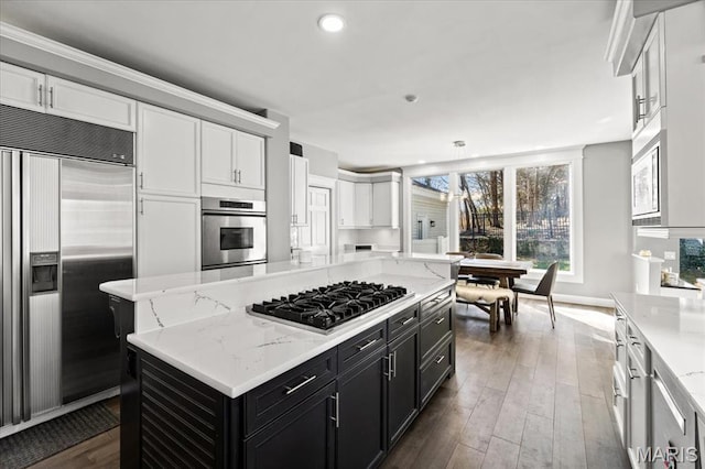 1909 Shepard Rd, Wildwood, MO 63038 - kitchen featuring built in appliances, dark cabinets, white cabinetry, a center island, and recessed lighting