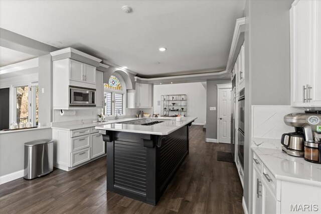 1909 Shepard Rd, Wildwood, MO 63038 - kitchen featuring stainless steel appliances, a center island, white cabinetry, a kitchen bar, and recessed lighting