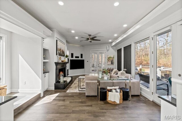 1909 Shepard Rd, Wildwood, MO 63038 - living room with recessed lighting, a lit fireplace, wood finished floors, a ceiling fan, and built in features