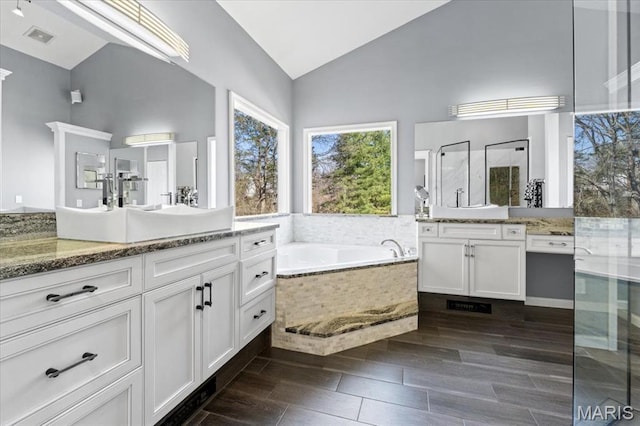 1909 Shepard Rd, Wildwood, MO 63038 - full bath featuring a stall shower, a bath, two vanities, and high vaulted ceiling