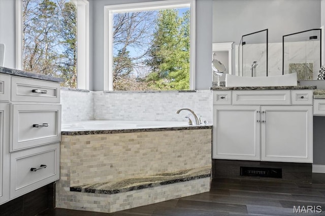 1909 Shepard Rd, Wildwood, MO 63038 - bathroom with plenty of natural light, a garden tub, vanity, and wood finished floors