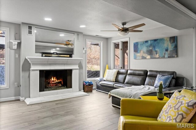 1909 Shepard Rd, Wildwood, MO 63038 - living room with a ceiling fan, wood finished floors, baseboards, recessed lighting, and a lit fireplace