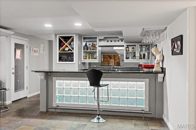 1909 Shepard Rd, Wildwood, MO 63038 - indoor wet bar with baseboards, stone finish flooring, recessed lighting, and healthy amount of natural light