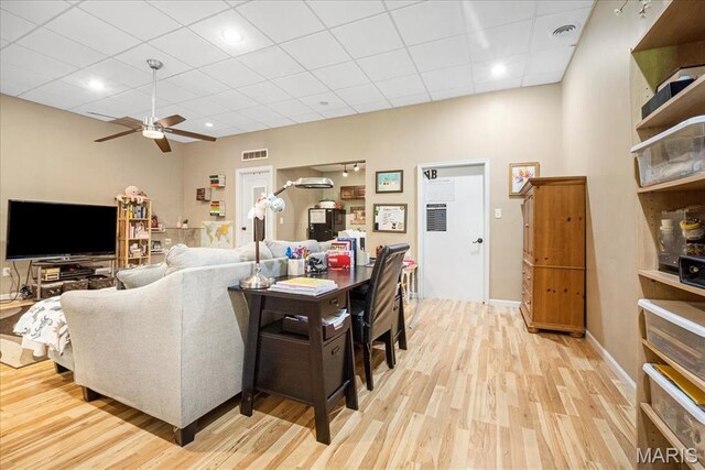 1909 Shepard Rd, Wildwood, MO 63038 - living room with wood finished floors, a ceiling fan, a paneled ceiling, and baseboards