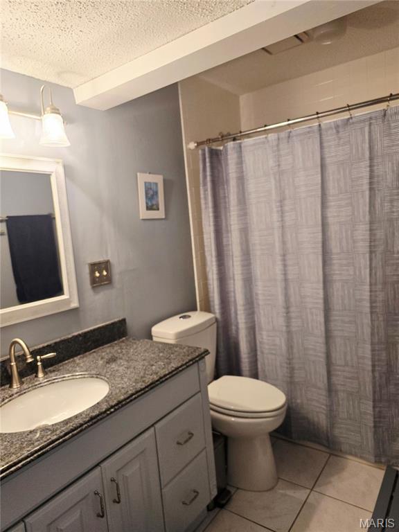 10340 Corbeil Dr, Saint Louis, MO 63146 - bathroom with vanity, toilet, tile patterned flooring, a textured ceiling, and curtained shower