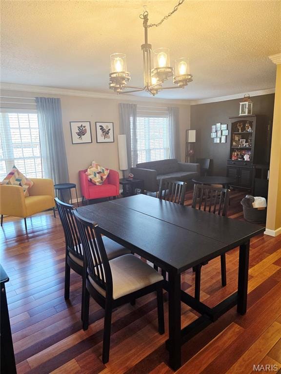 10340 Corbeil Dr, Saint Louis, MO 63146 - dining space featuring a chandelier, crown molding, a textured ceiling, and wood finished floors