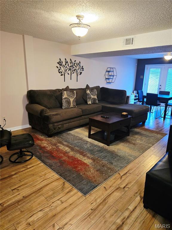 10340 Corbeil Dr, Saint Louis, MO 63146 - living area with a textured ceiling and hardwood / wood-style floors