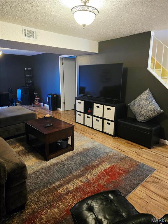 10340 Corbeil Dr, Saint Louis, MO 63146 - living area with a textured ceiling and wood finished floors