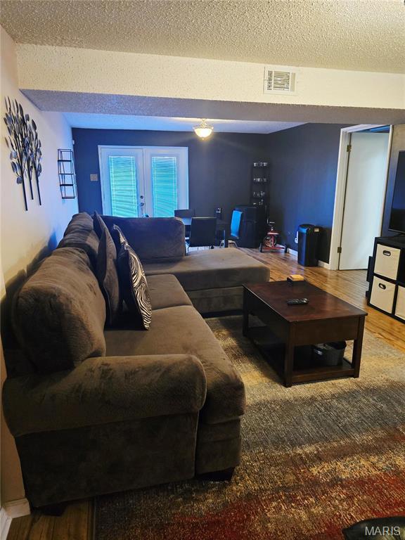 10340 Corbeil Dr, Saint Louis, MO 63146 - living area with a textured ceiling and wood finished floors