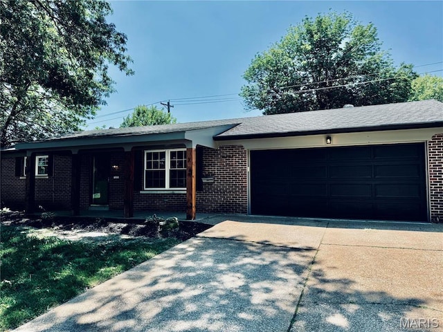 133 Winthrop Dr, Belleville, IL 62221 - ranch-style home featuring brick siding, an attached garage, concrete driveway, and covered porch