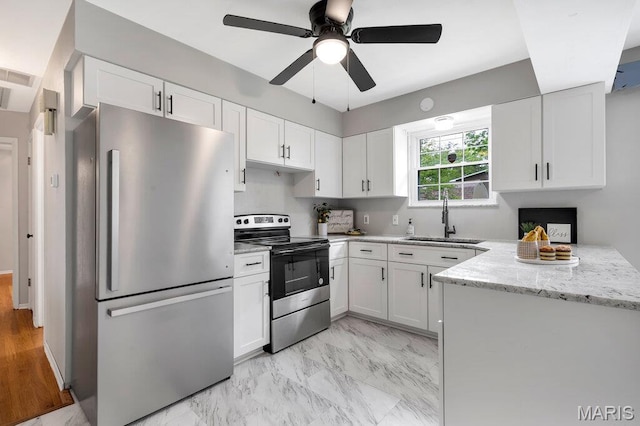 133 Winthrop Dr, Belleville, IL 62221 - kitchen featuring stainless steel appliances, a sink, white cabinetry, and light stone counters