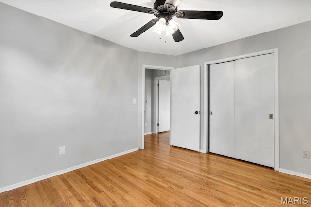 133 Winthrop Dr, Belleville, IL 62221 - unfurnished bedroom featuring baseboards, light wood-style floors, a closet, and a ceiling fan