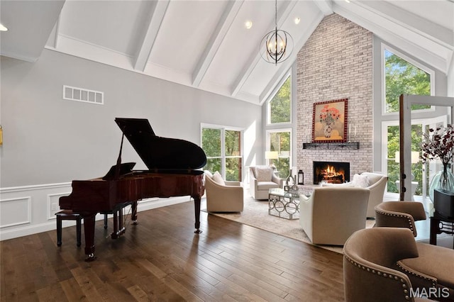 13552 Weston Park Dr, Saint Louis, MO 63131 - sitting room featuring high vaulted ceiling, a chandelier, a fireplace, beamed ceiling, and dark wood finished floors