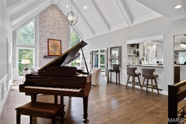 13552 Weston Park Dr, Saint Louis, MO 63131 - living area featuring high vaulted ceiling, a chandelier, hardwood / wood-style floors, beamed ceiling, and a decorative wall