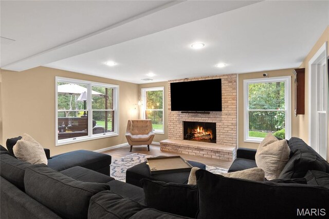 13552 Weston Park Dr, Saint Louis, MO 63131 - living room featuring wood finished floors, a fireplace, baseboards, and recessed lighting