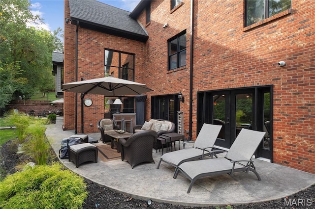13552 Weston Park Dr, Saint Louis, MO 63131 - back of house featuring french doors, brick siding, outdoor lounge area, and a patio area