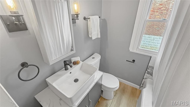4411 Nelson Dr, Saint Louis, MO 63121 - bathroom with wood finished floors, toilet, and vanity