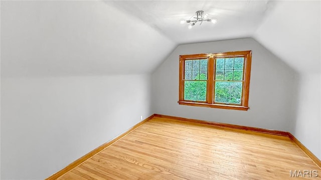 4411 Nelson Dr, Saint Louis, MO 63121 - bonus room featuring wood finished floors, baseboards, and lofted ceiling