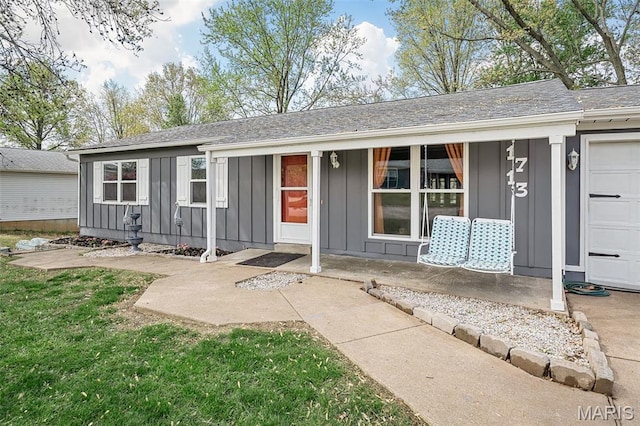 single story home with board and batten siding and covered porch