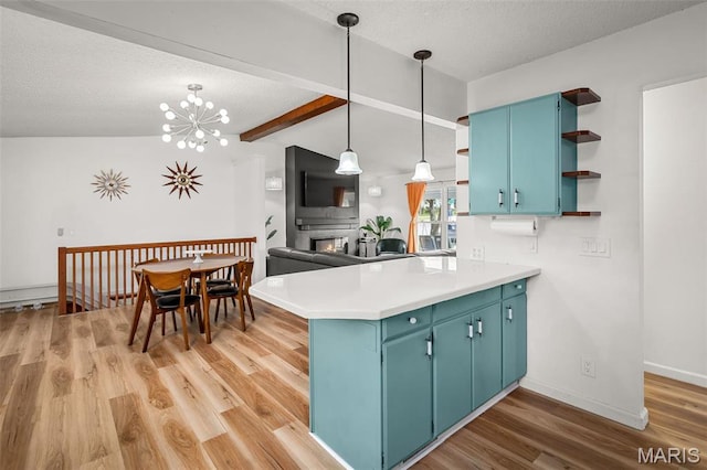 kitchen with open shelves, a peninsula, beam ceiling, light wood-style floors, and blue cabinets