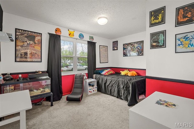 bedroom featuring a textured ceiling and carpet flooring