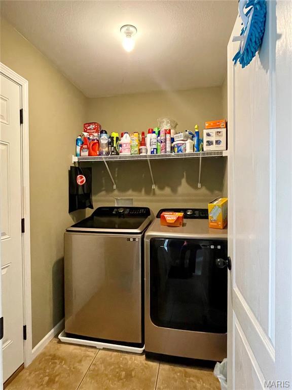 22880 Return Ln, Waynesville, MO 65583 - washroom featuring separate washer and dryer and light tile patterned floors
