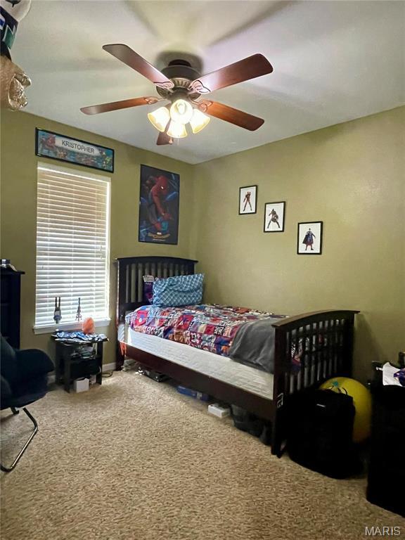 22880 Return Ln, Waynesville, MO 65583 - carpeted bedroom featuring a ceiling fan