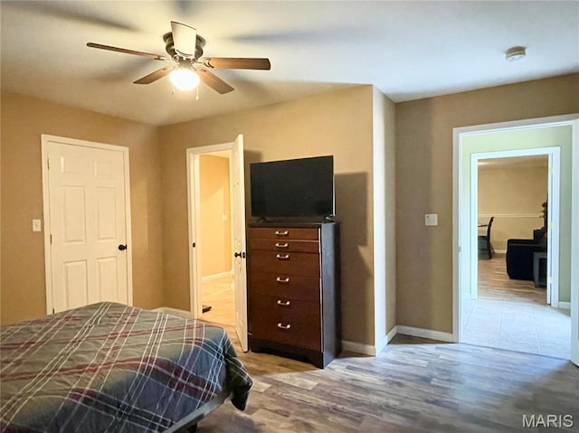 22880 Return Ln, Waynesville, MO 65583 - bedroom with baseboards, wood finished floors, and ceiling fan