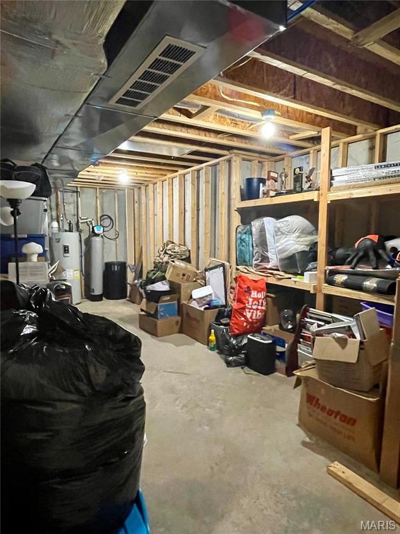 22880 Return Ln, Waynesville, MO 65583 - unfinished below grade area with electric water heater, heating unit, and a water softener system