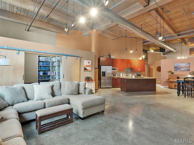 901 Washington Ave Unit 205, Saint Louis, MO 63101 - living room with a towering ceiling, finished concrete floors, beam ceiling, and wooden ceiling