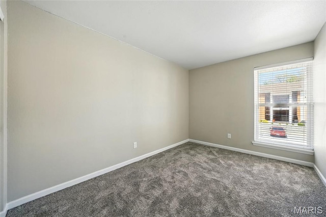 carpeted spare room with baseboards