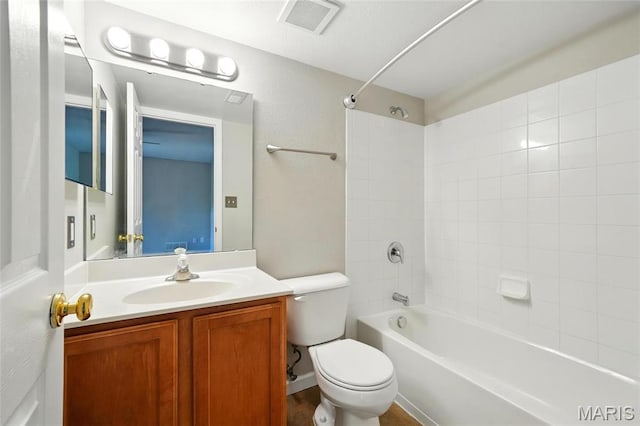 bathroom featuring toilet, tub / shower combination, and vanity