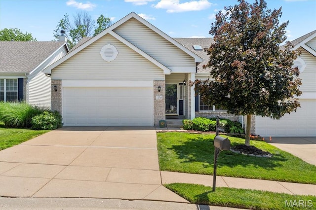 1136 Arbor Place Dr, Manchester, MO 63088 - ranch-style home with concrete driveway, a front yard, a garage, and brick siding