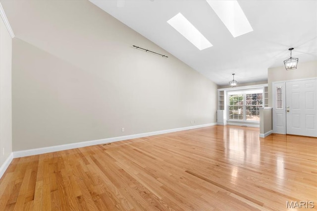 1136 Arbor Place Dr, Manchester, MO 63088 - unfurnished living room with a skylight, light wood-style floors, high vaulted ceiling, and a chandelier