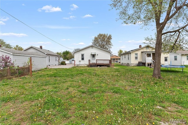 120 E 1st St, Hartford, IL 62048 - view of yard featuring a trampoline, a deck, and a patio