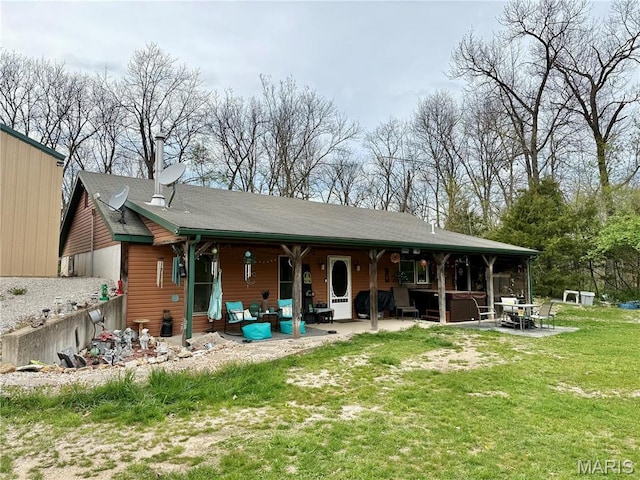 42 Berger Rd, Middletown, MO 63359 - back of house with a patio, a lawn, and a jacuzzi