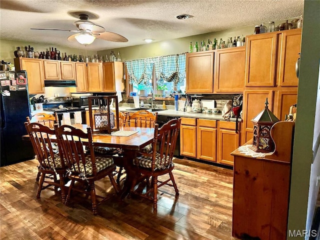 42 Berger Rd, Middletown, MO 63359 - kitchen featuring black appliances, range hood, ceiling fan, light wood-type flooring, and a textured ceiling